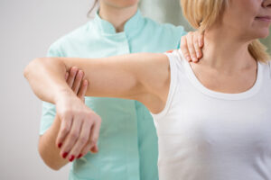 kinesiologist carrying out muscle testing on a client, therapist work to balance meridians (or acupressure points) throughout the treatment session