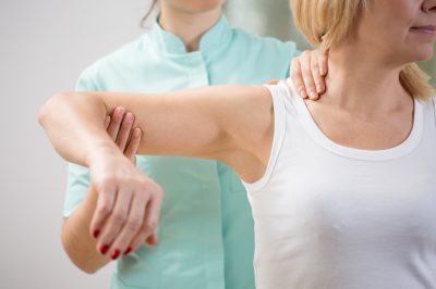 kinesiologist and patient during muscle testing